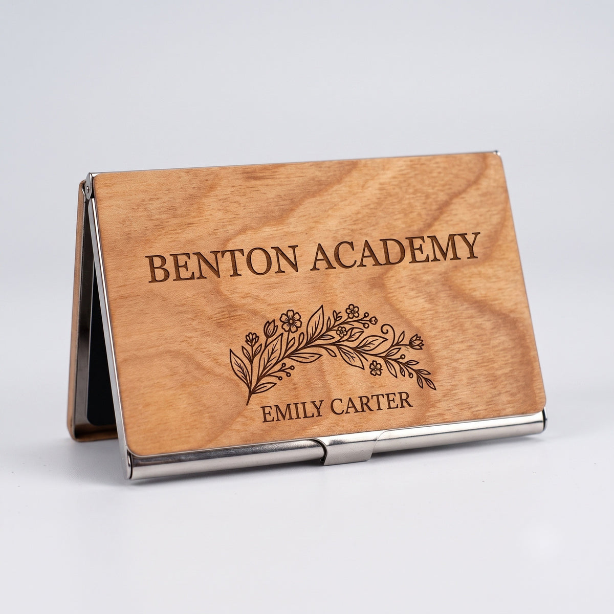 Personalized academy crest engraving on wooden card case standing upright